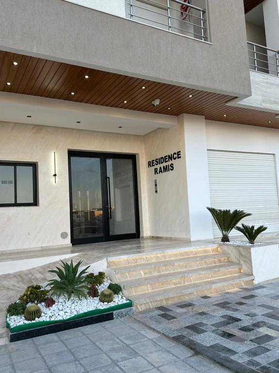 a building with a entrance to ansicsnsicsnsics hands sign on it at Apartment in Sousse in Sousse
