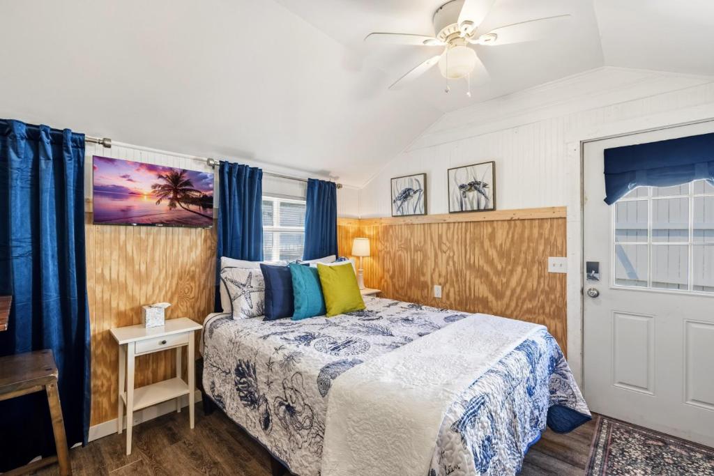 a bedroom with a bed and a ceiling fan at Fisher Flats Downstairs in Cedar Key