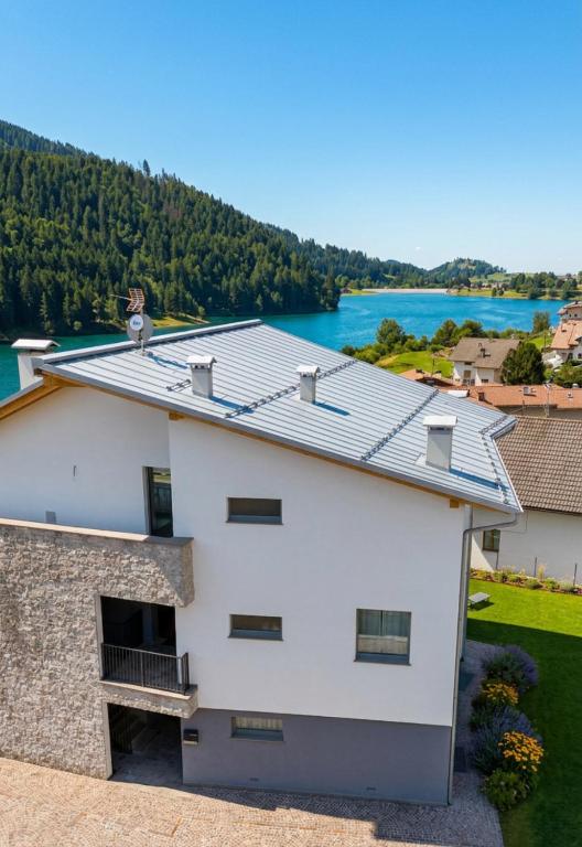 a white house with a view of the water at Sognatrentino in Cialini