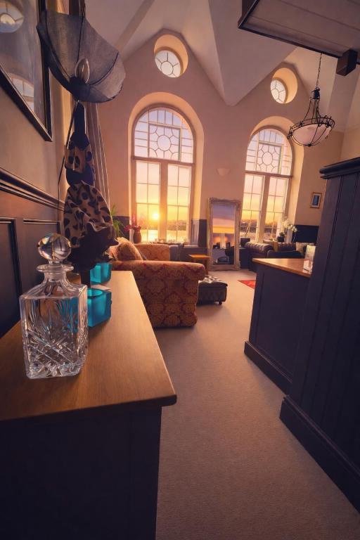 a living room with a couch and a table at The Old Court House & Jail in Menai Bridge