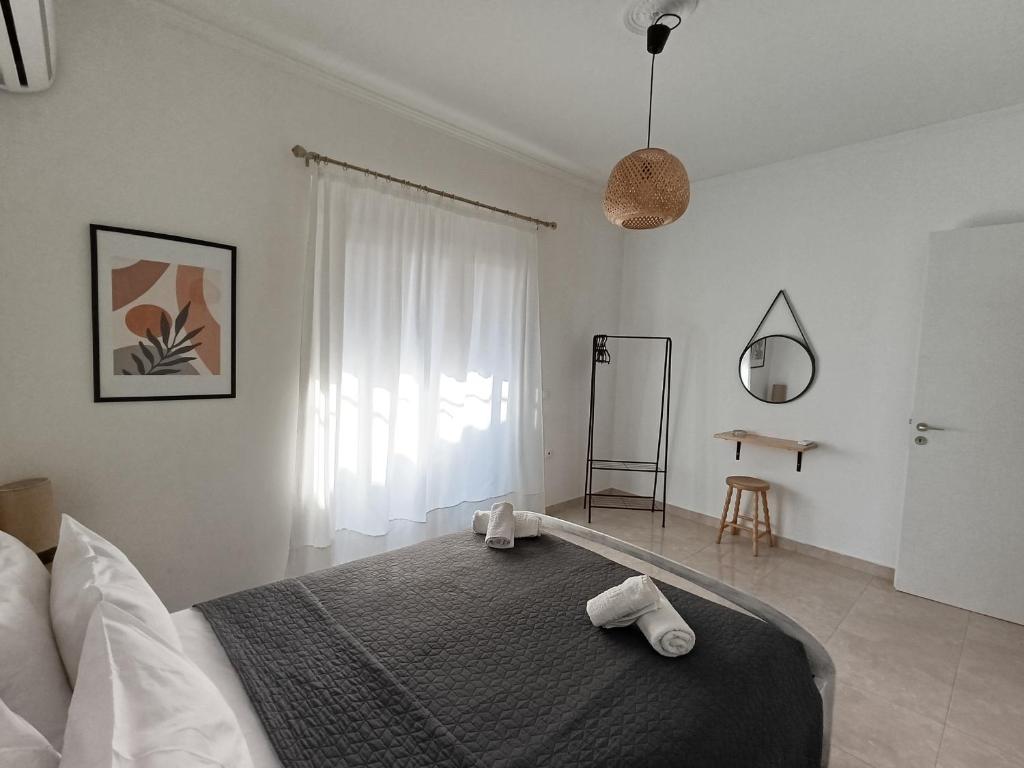 a bedroom with a bed with two towels on it at Bougainvillea Apartment Spacious Family Home in Zakynthos Town in Zakynthos