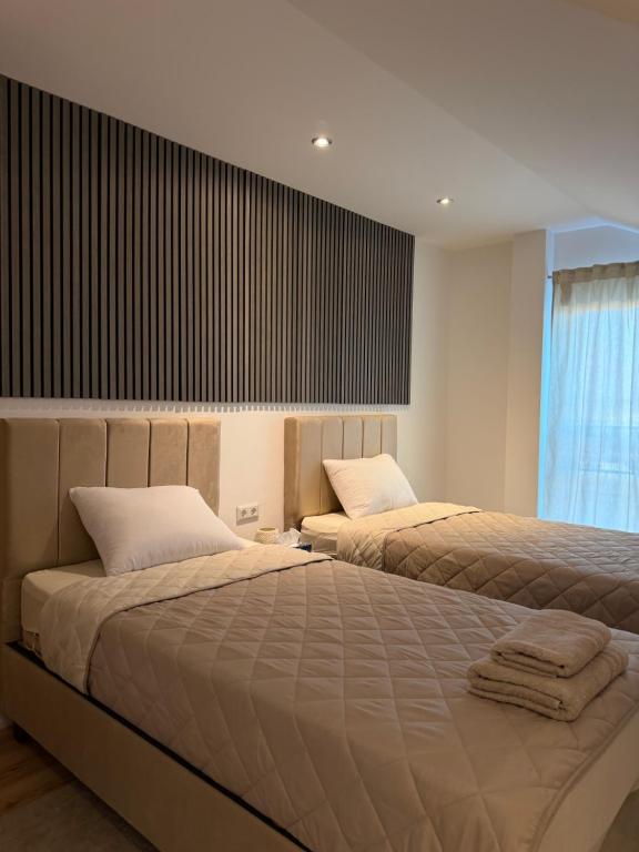 two beds sitting next to each other in a bedroom at URBAN House Vienna in Gerasdorf bei Wien