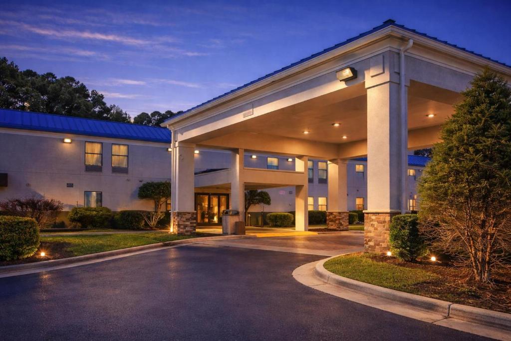 a large building with a driveway in front of it at Americas Best Value Inn Raleigh in Raleigh