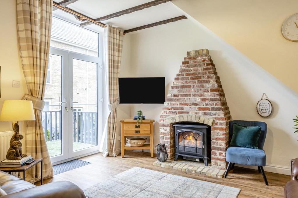 a living room with a brick fireplace and a tv at 2 Bed in Shanklin oc-c36037 in Shanklin