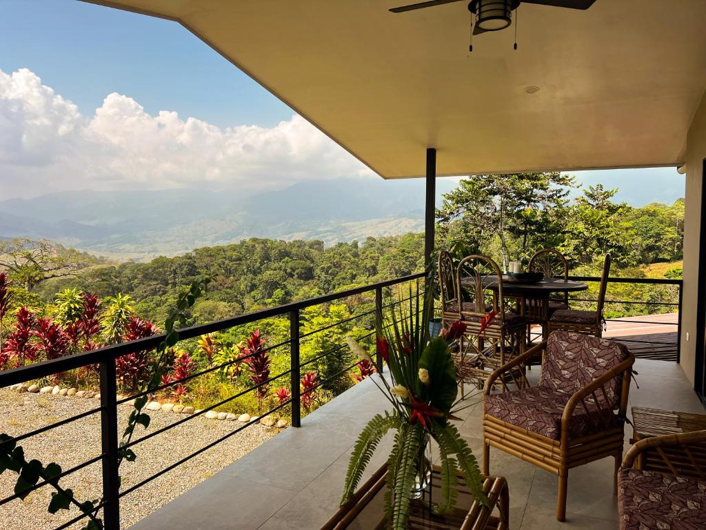a balcony of a house with a view of the mountains at Luxury In The Jungle in Barú