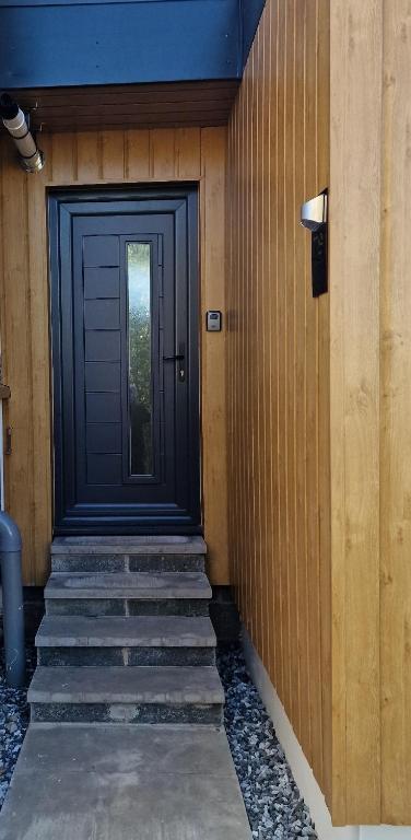 a door to a house with stairs leading to it at Nivahana in Edinburgh