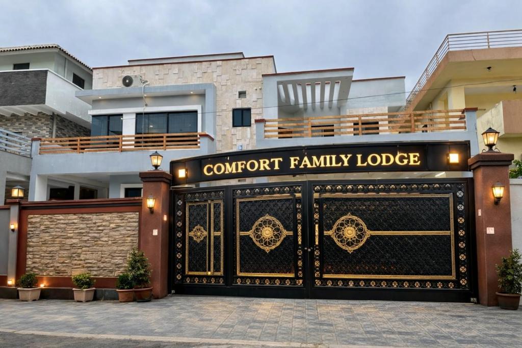 a front gate of a house with a court family lodge at Comfort Family Lodges Islamabad in Islamabad