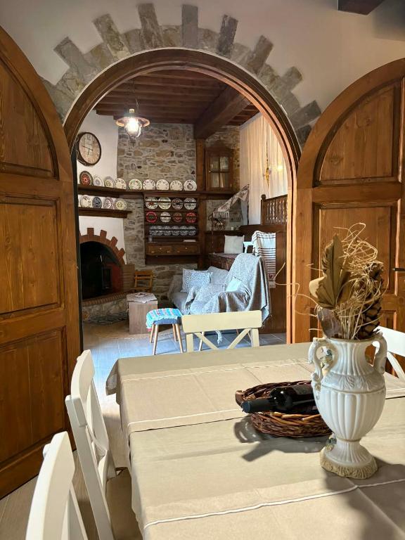 a dining room with a table with a vase on it at Casa Charma in Émbonas