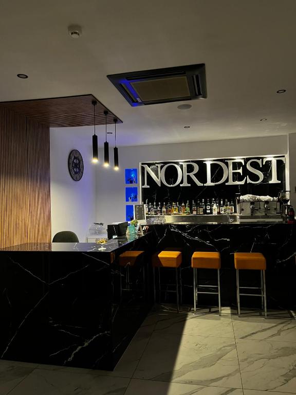a bar in a restaurant with a sign that reads northeast at Hotel Nord Est in Riccione