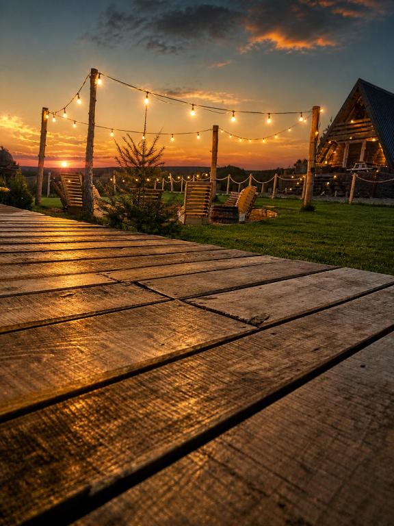 a wooden walkway with a string of lights at Krushevski Konaci 1 in Kruševo