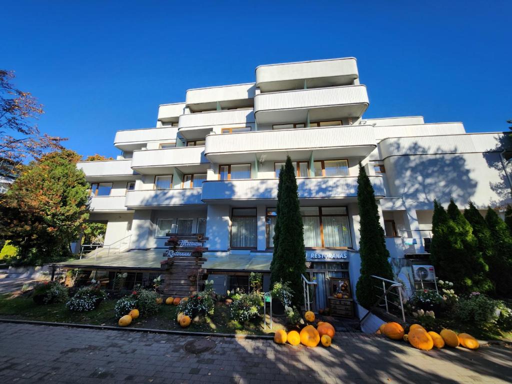 a white building with pumpkins in front of it at To Be Apartament Palanga in Palanga