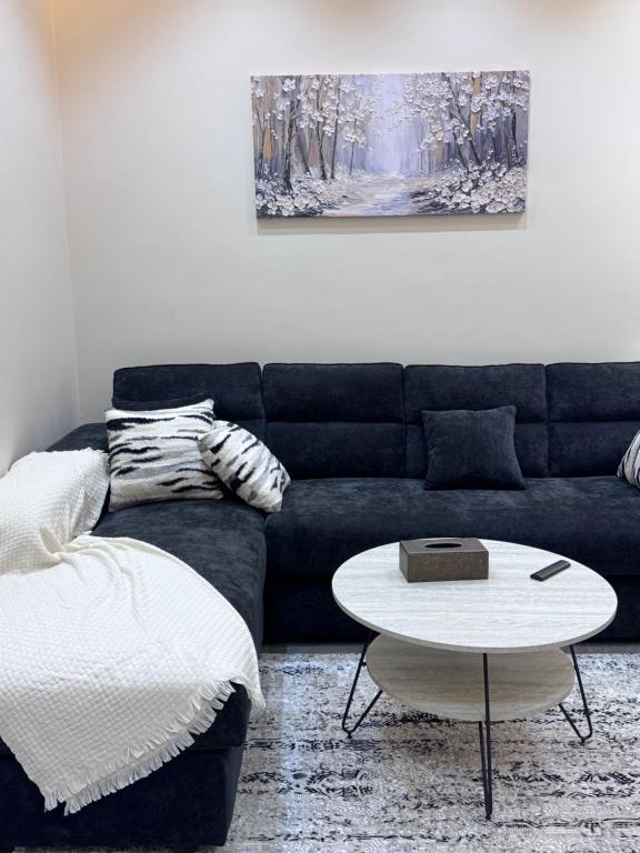 a living room with a couch and a table at Misk Apartment in Jeddah
