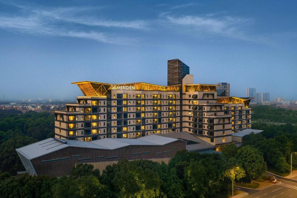 a large building with a tower on top of it at Le Méridien Changzhou in Changzhou