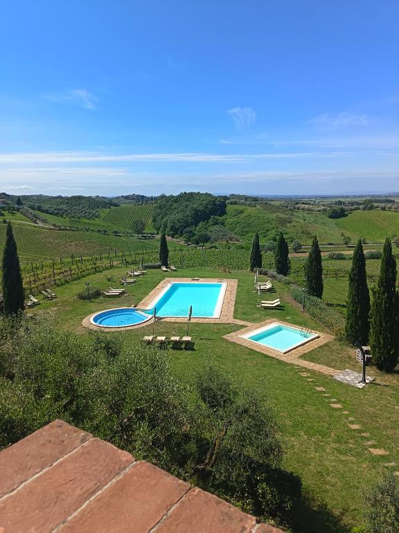 an aerial view of two swimming pools in a field at Agriturismo Corte in Poggio in Stabbia