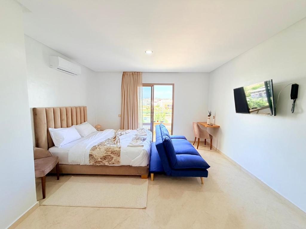 a bedroom with a large bed and a window at Stay with US in Agadir