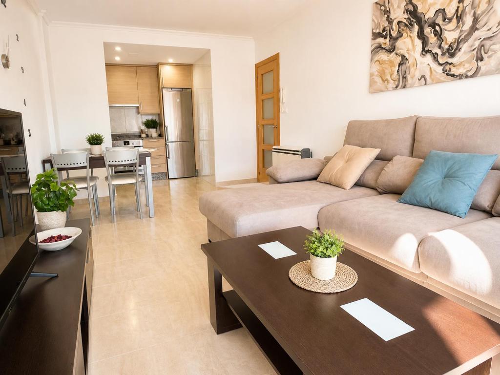 a living room with a couch and a table at Apartamento vistas al mar in Viveiro
