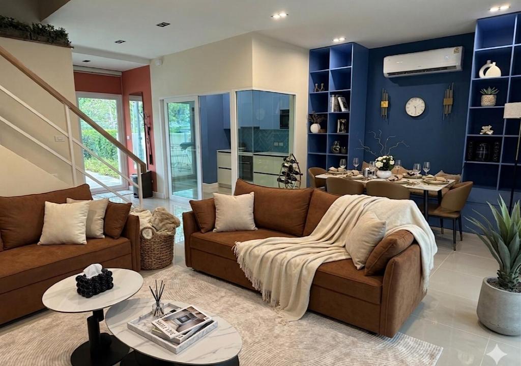a living room with a couch and a dining room at SvoyLuX Primo 3BR Gated House Near Pier and Muay Thai Street in Phuket