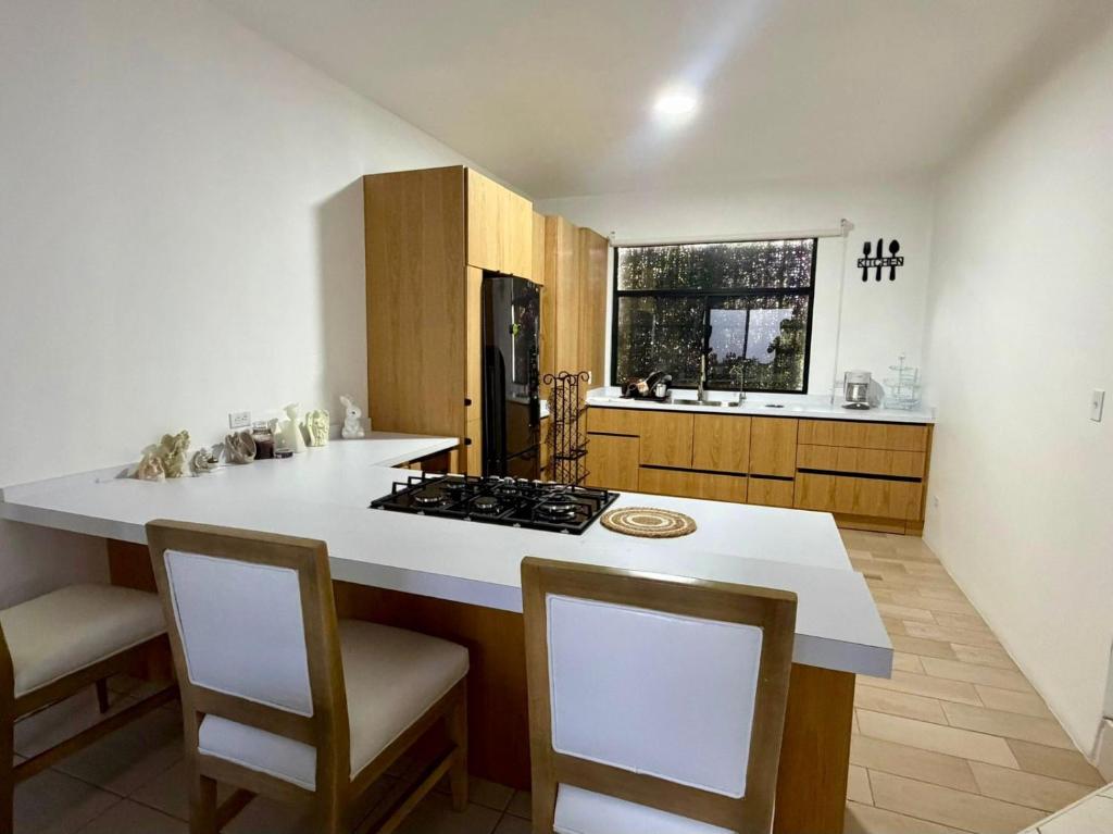 a kitchen with a white counter top and a stove at Casa Costa Hermosa in Tijuana