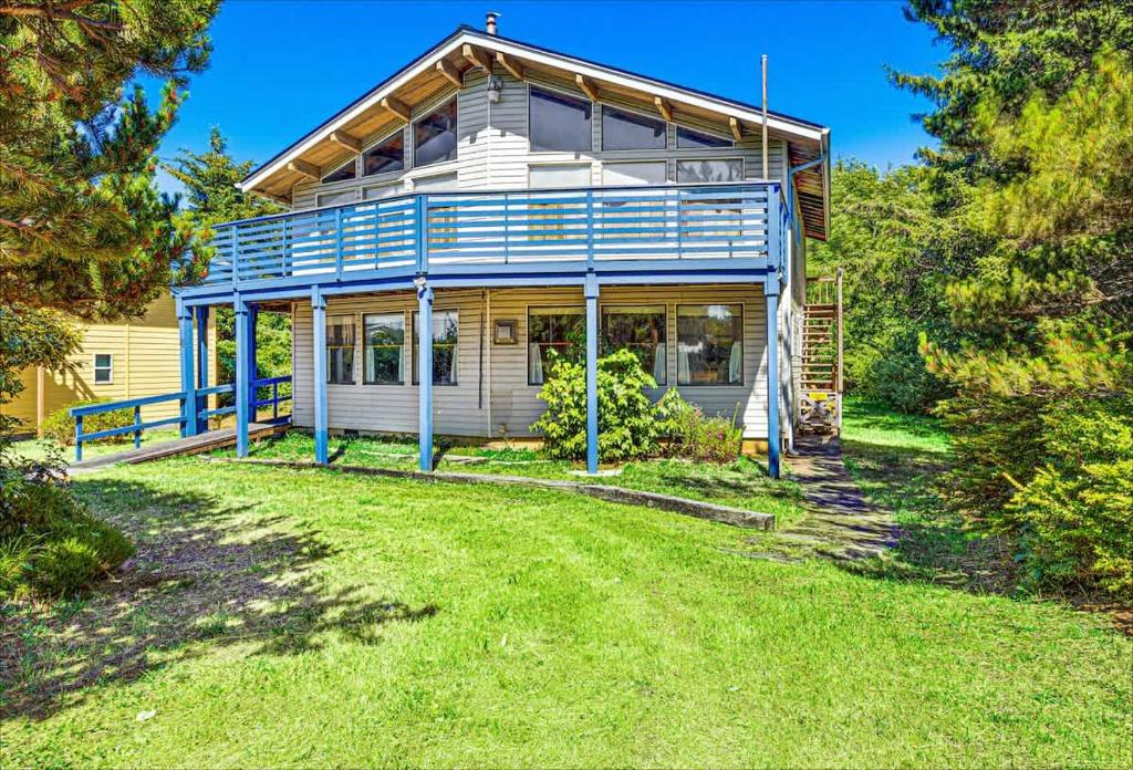 a house with a large yard in front of it at Cozy Copalis Beach Cottage Escape in Copalis Beach