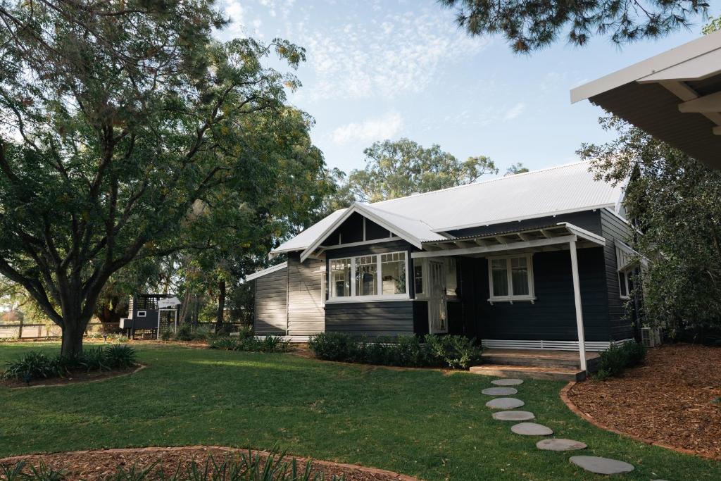 a black house with a gray roof at The Foxman Cottage in Broke