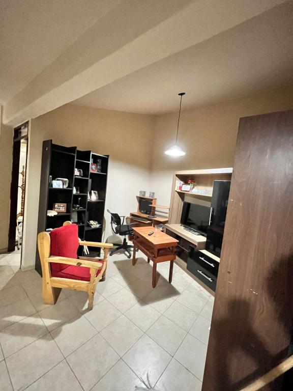 a living room with a desk and a chair and a table at Casa Bella Vista in Pocito