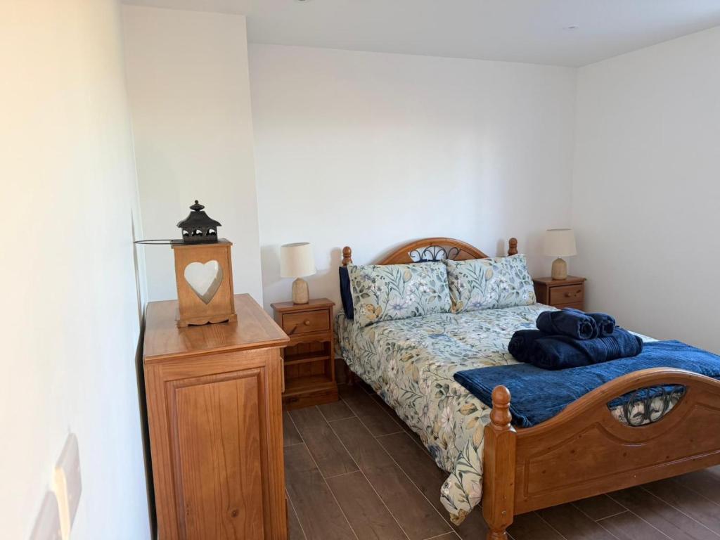 a bedroom with a bed and a nightstand and a bed sidx sidx sidx sidx at The Cottage in Ballaghaderreen
