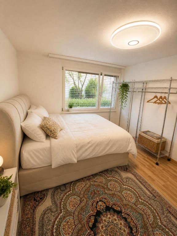 a bedroom with a large bed and a window at Bern Garden Residence 152m Luxury Apartment in Bern