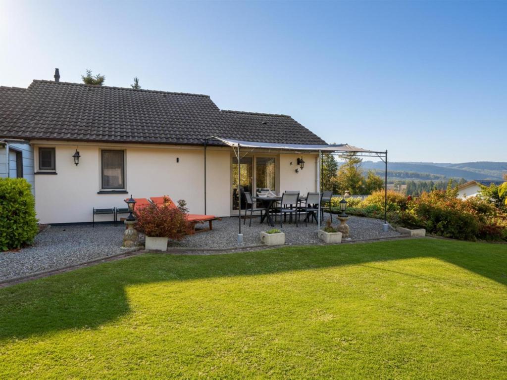 a house with a large lawn in front of it at Coeur de Biche in Rendeux