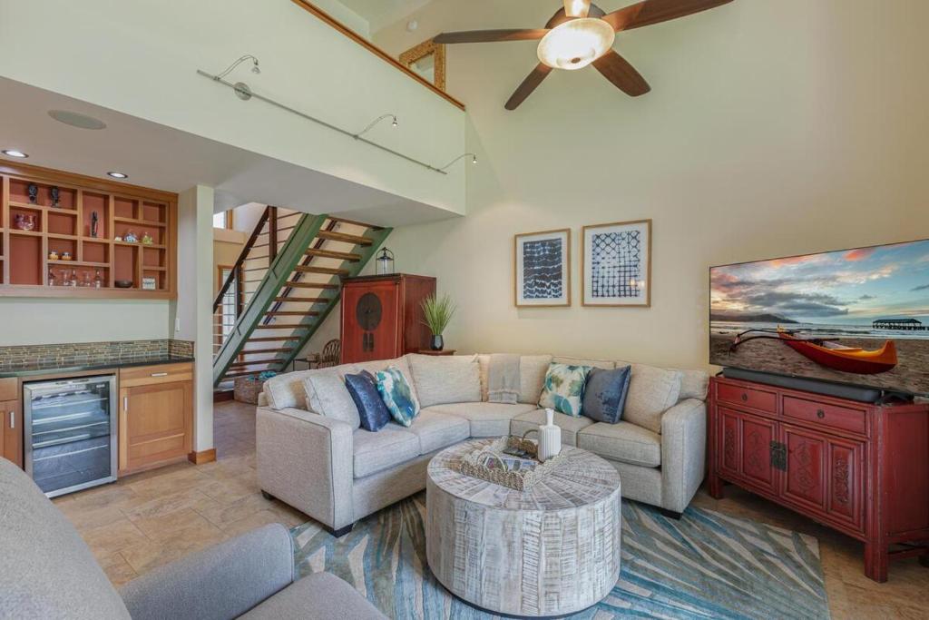 a living room with a couch and a table at Puamana 19C in Princeville