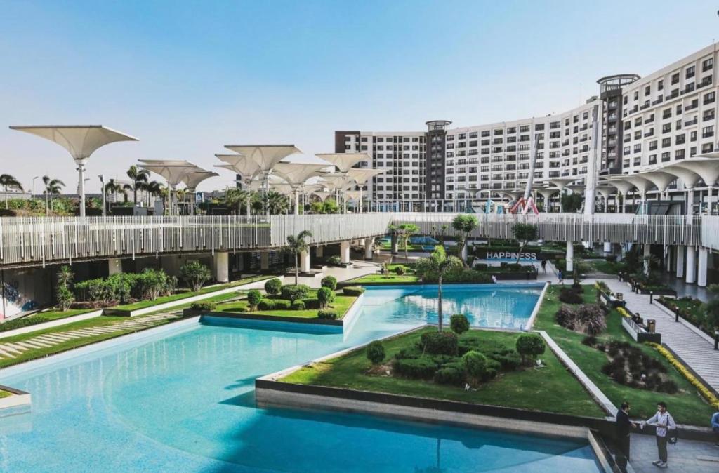 a view of a resort with a large swimming pool at Duplex-Nyoum New Cairo in Cairo