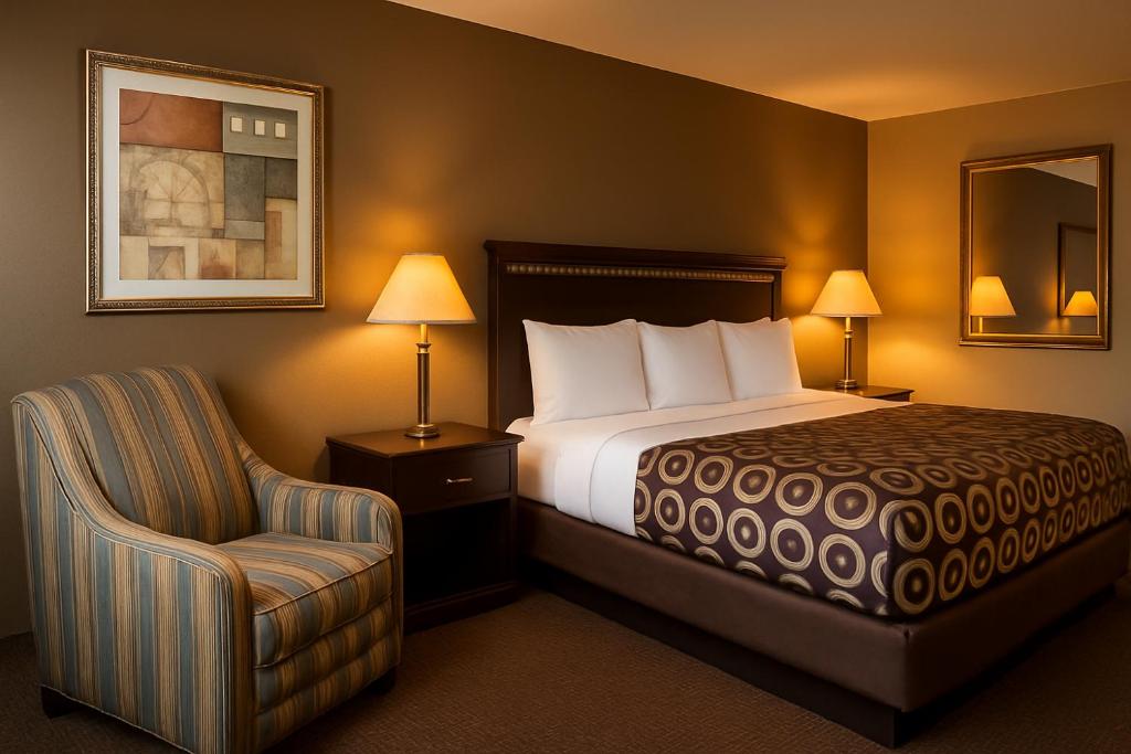 a hotel room with a bed and a chair at MHO Hotel Eloy Casa Grande Near I-10 in Eloy