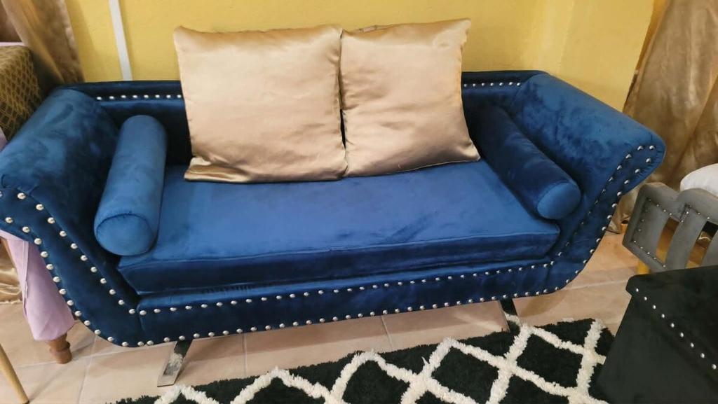 a blue couch with a pillow on top of it at Comfort Suites - Studio Two in La Fargue