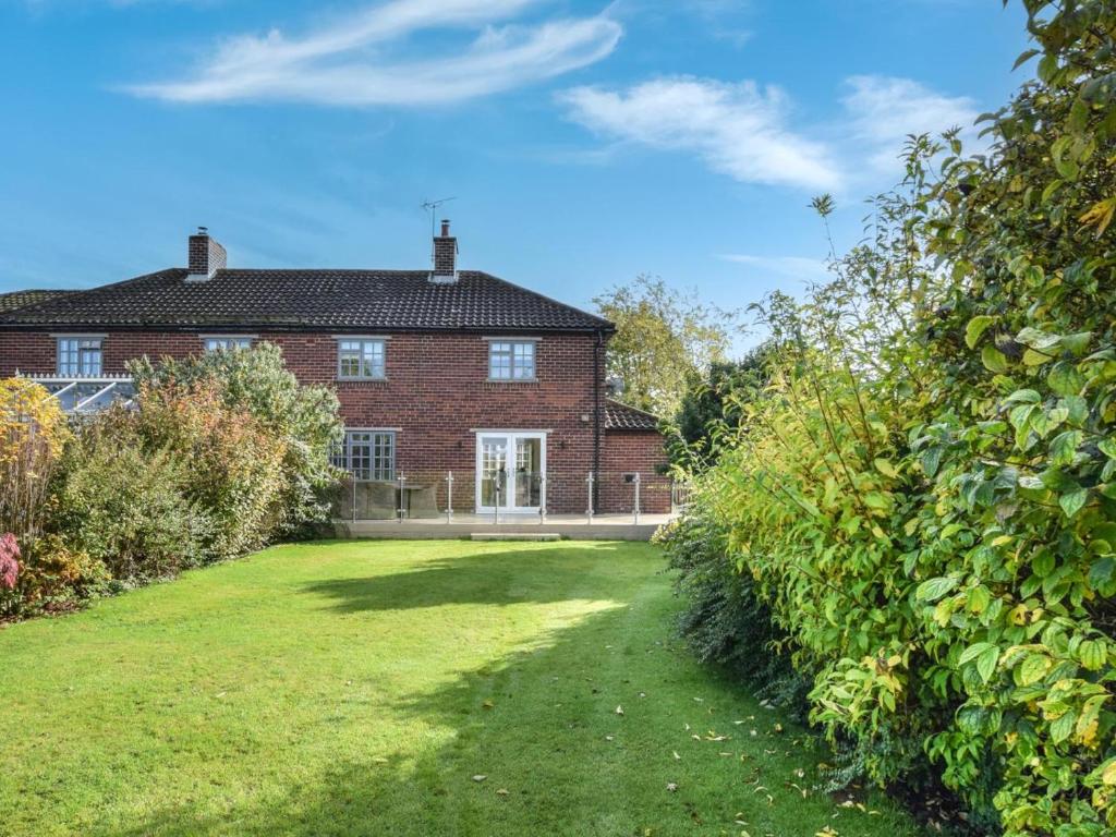 an exterior view of a brick house with a yard at 3 Bed in York oc-hh015 in Tockwith