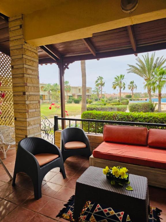 a living room with a couch and chairs on a porch at casabianca north coast chalet code 20 in Borg El Arab