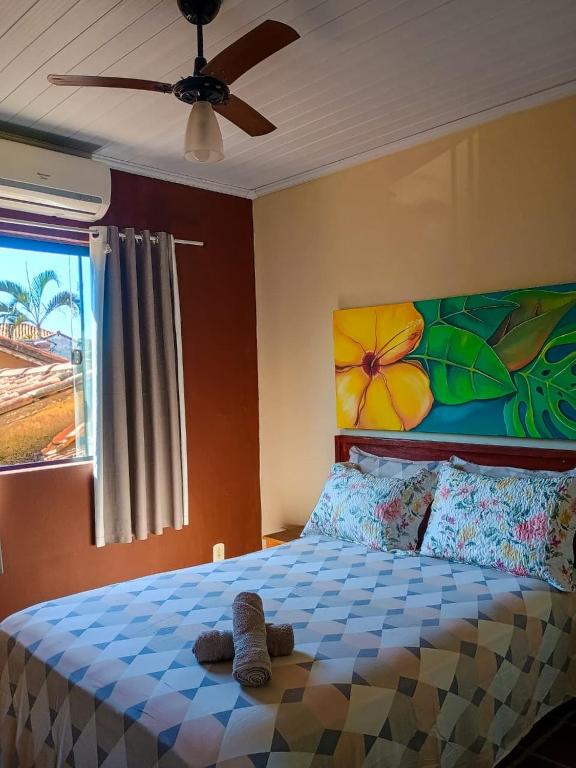 a bedroom with a bed with a stuffed animal on it at Apto Centro de Búzios - 2 Quartos - Ar-condicionado in Búzios
