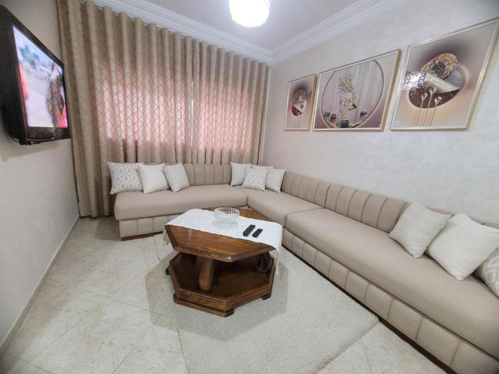a living room with a couch and a coffee table at Cozy apartment center, Larache in Larache