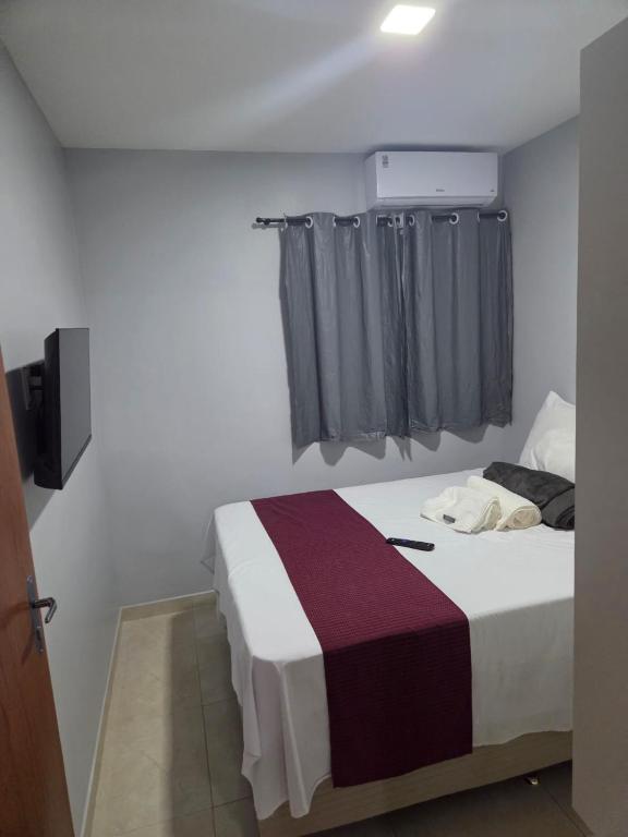 a bedroom with a large bed with a window at pajuçara R2 in Maceió