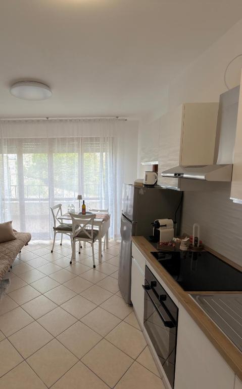 a kitchen with a table and a dining room at Malpensa Stay Express Self check-in in Gallarate