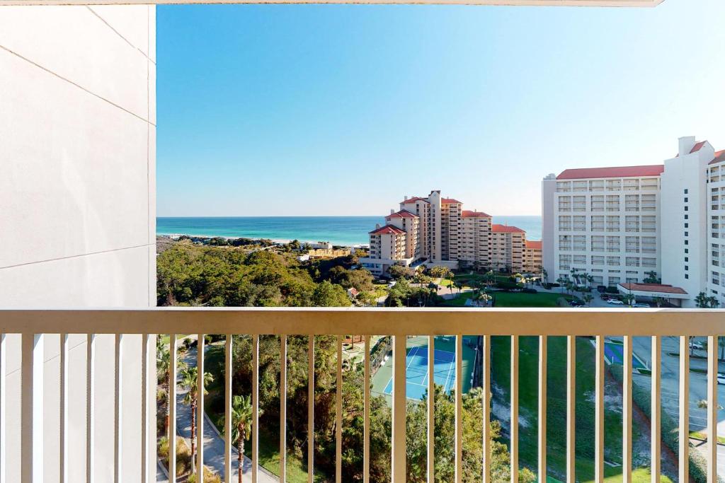 a balcony with a view of the ocean and buildings at TOPS'L Summit 1013 in Destin