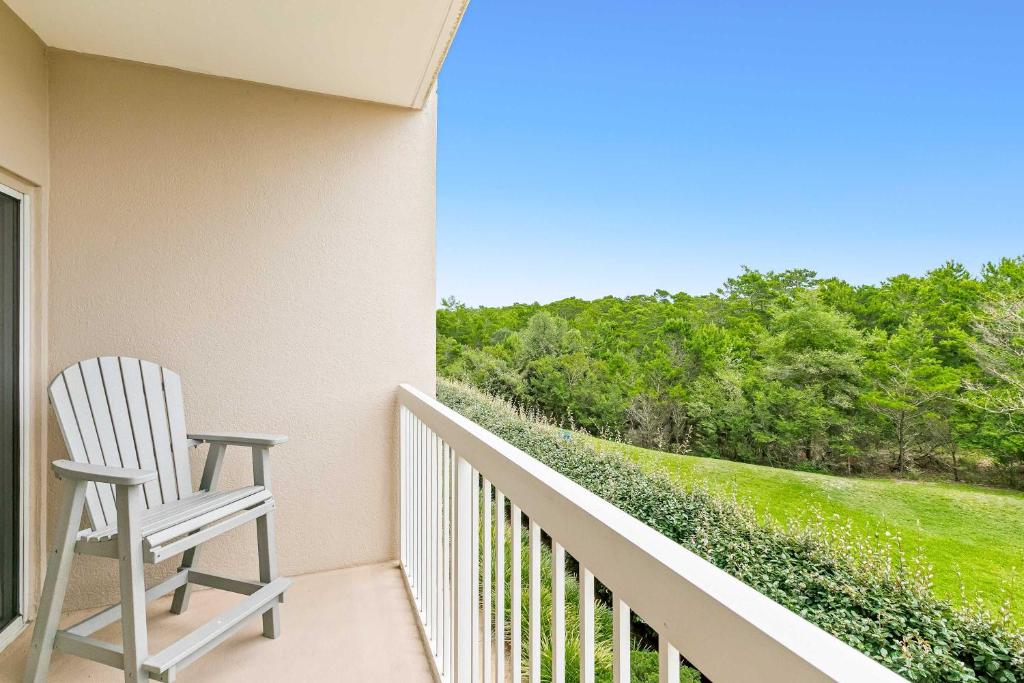 a white chair sitting on a balcony with a view at TOPS'L Summit 207A in Destin