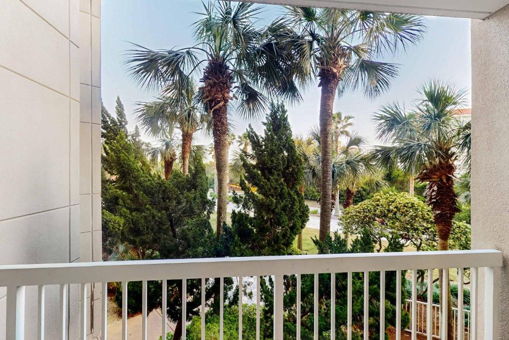 a view of palm trees from a balcony at TOPS'L Summit 210 in Destin