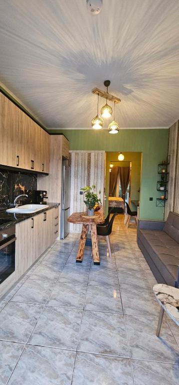 a kitchen with a table in the middle of a room at Alora Cosy Suite in Kefalos