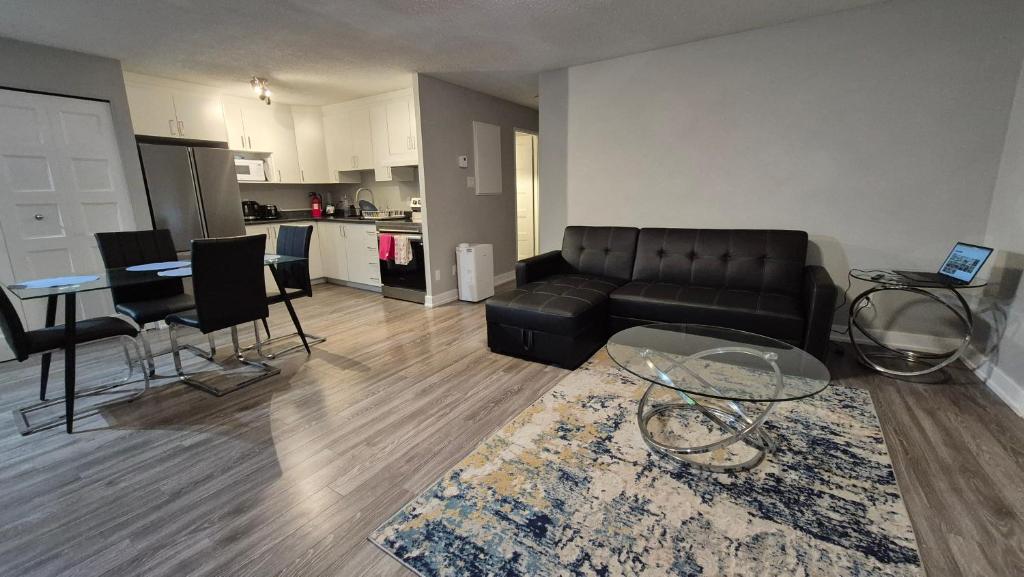 a living room with a leather couch and a table at Messila in Gatineau