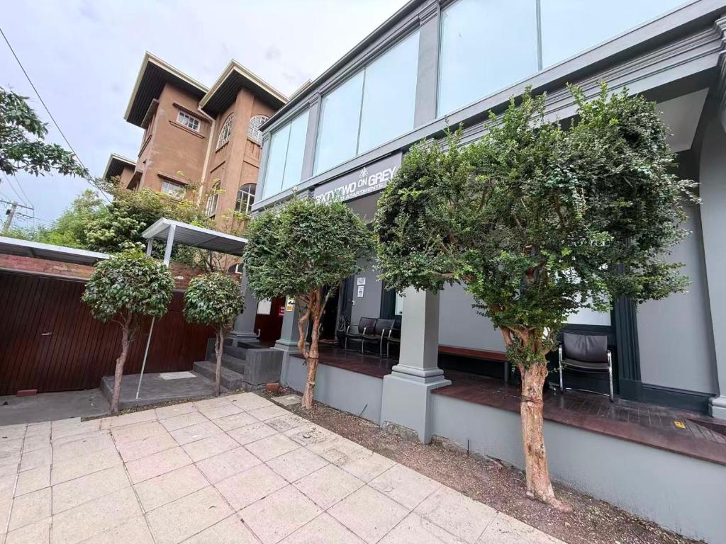 a group of trees in front of a building at Sixty Two On Grey Serviced Apartments in Melbourne