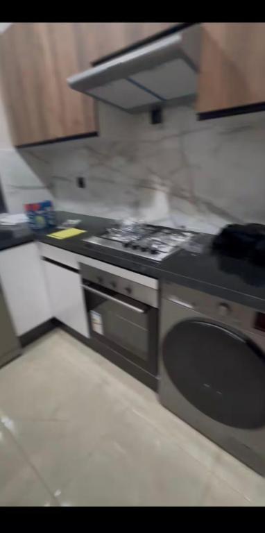 a kitchen with a stove and a sink at Chambre avec WC privée pr 1p dans un appart partagé avec 1p in Sidi Maarouf