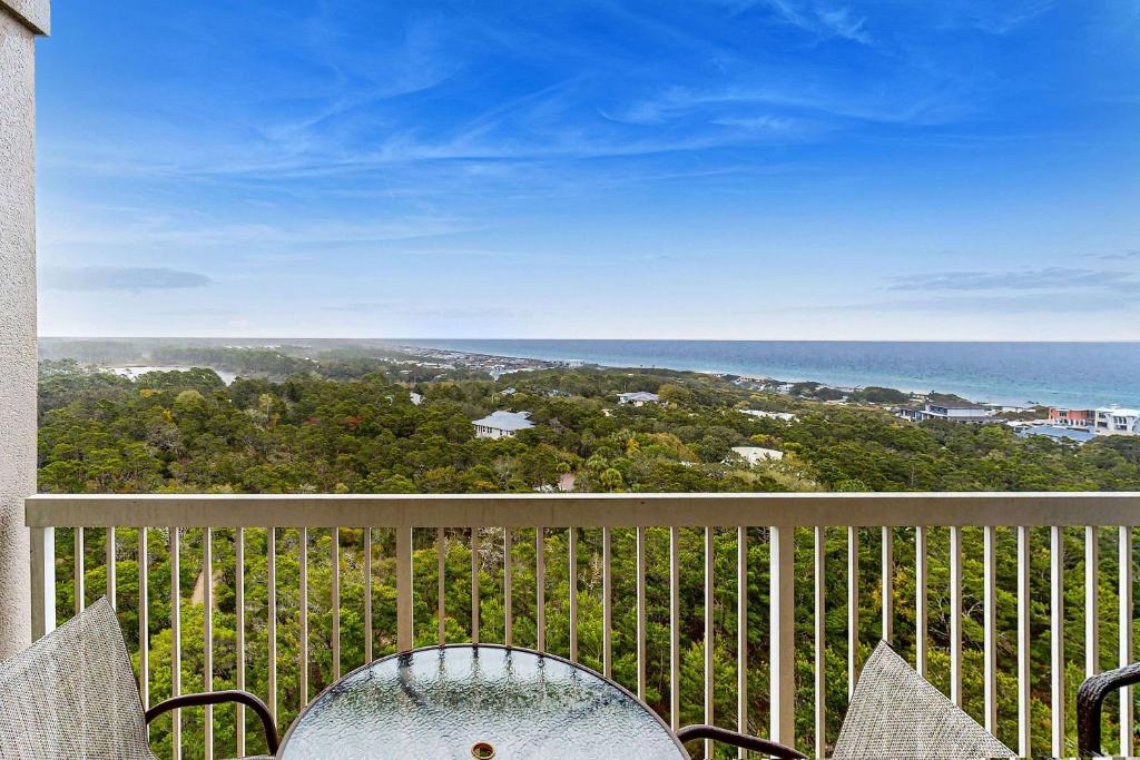 a view of the ocean from a balcony with a chair at Top-Floor Studio with Ocean Views and Pool in Destin