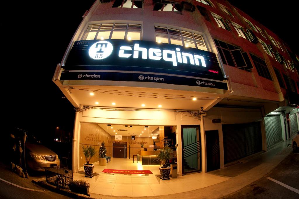 a building with a sign on the front of it at Hotel Cheqinn in Ipoh