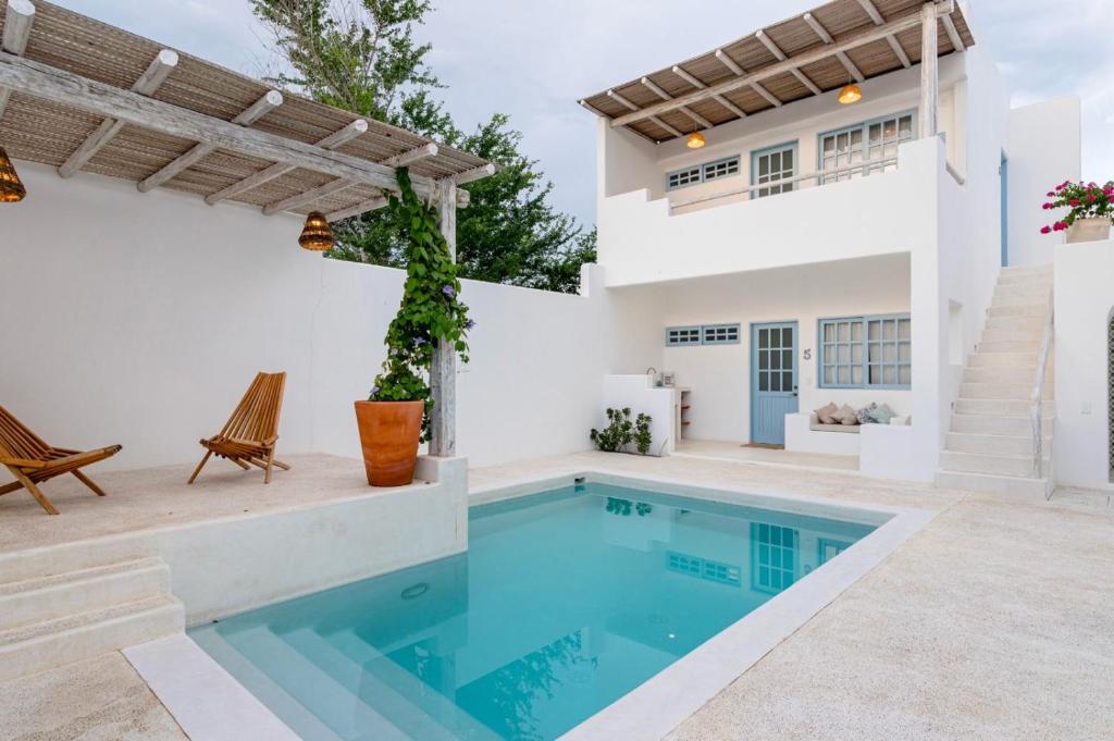 a villa with a swimming pool and a house at Punta Mayia in Brisas de Zicatela