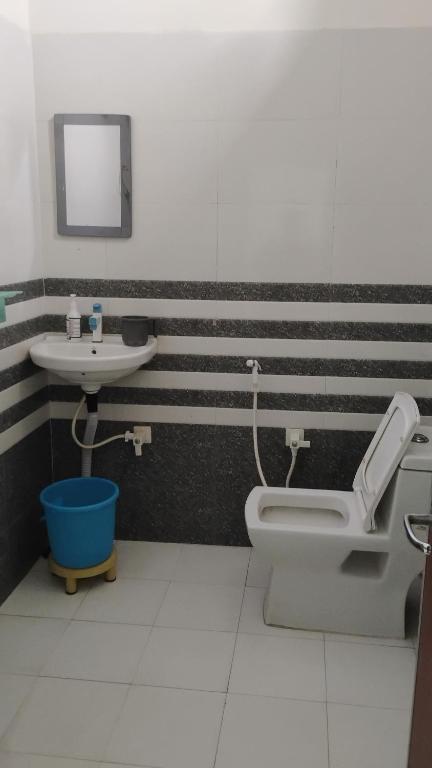 a bathroom with a toilet and a sink at SR Resort Ateli in Ateli