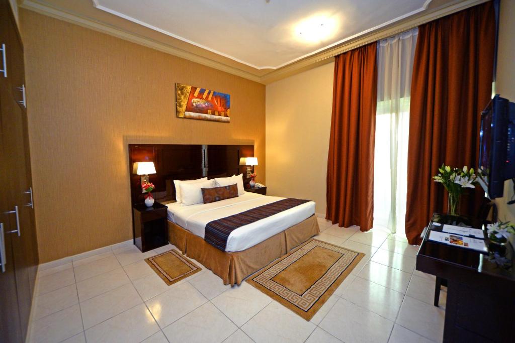 a hotel room with a bed and a large window at Emirates Stars Hotel Apartments Dubai in Dubai